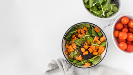  Green salad with sweet potatoes and sesame seeds. Vegan dish. Healthy eating. Copy space