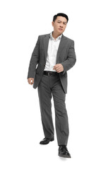 Obraz na płótnie Canvas Businessman in suit walking on white background, low angle view