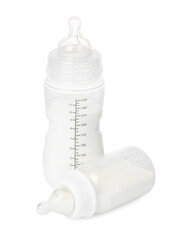 Two feeding bottles with infant formula on white background