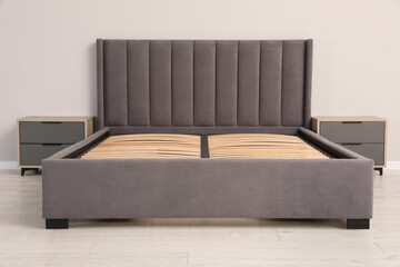 Comfortable bed with storage space for bedding under slatted base in room