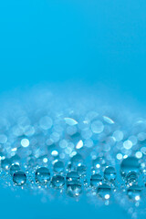 Water drops.Blue glitter shiny background. Defocused background water drops. Blurred bokeh background.
