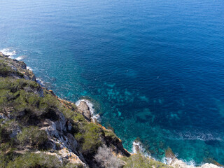 Fototapeta na wymiar Beautiful rocky shore of Mallorca Island, Balearic Islands, Spain. High cliffs, blue sea. 