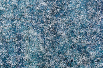 Macro frost.Icy frost, white crystals of frost on a blue background.Abstract texture of frost.