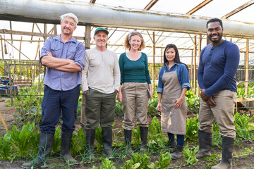 Farmer's team standing together in greenhouse