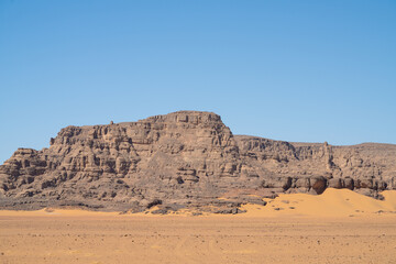 Fototapeta na wymiar view in the Sahara desert of Tadrart rouge tassili najer in Djanet City ,Algeria.colorful orange sand, rocky mountains