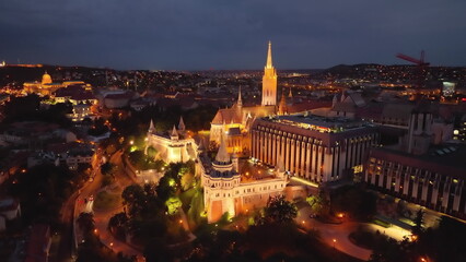 4K drone flying at illuminated Fisherman's Bastion by Matthias Church with clocktower. Budapest,...