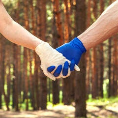 Hands in medical gloves.Two hands in rubber gloves holding each other. The concept of romantic...