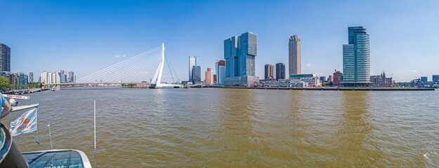 View over the Maas river to the city center of Rotterdam with Erasmus bridge during the day - obrazy, fototapety, plakaty
