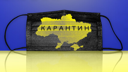 Black face mask with map of Ukraine and text on Ukrainian Lockdown. Ukraine in yellow quarantine zone.
