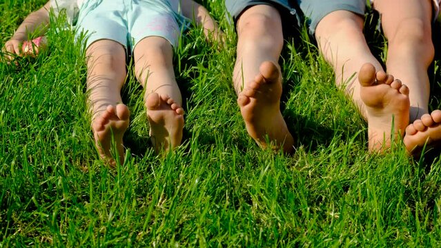 Children feet on the grass. Selective focus.