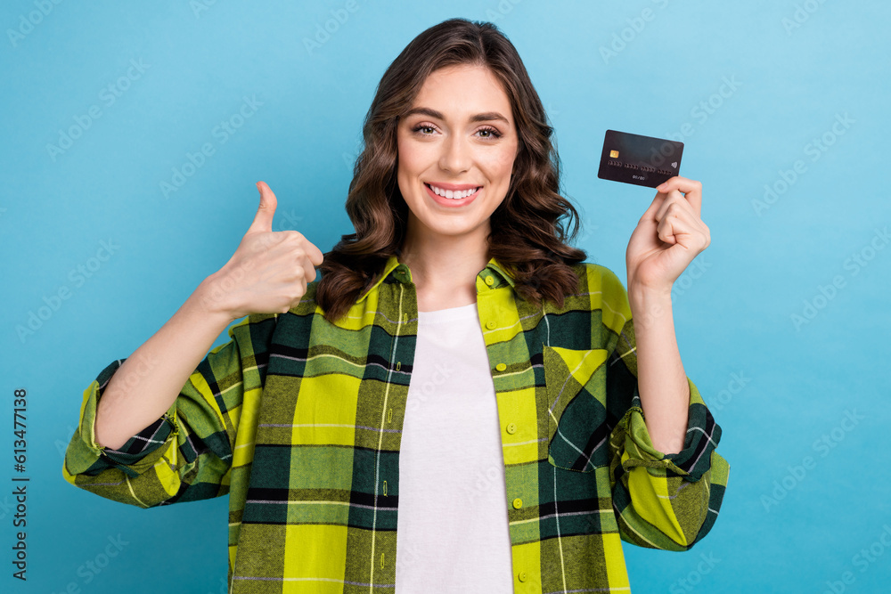 Poster photo of funky confident lady wear checkered jacket showing thumb up holding credit card isolated bl