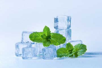 Ice cubes and fresh mint leaves, isolated on blue background  © zhikun sun