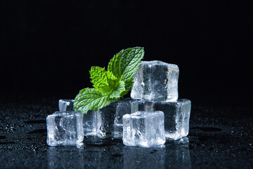 Ice cubes and fresh mint leaves isolated on black background	