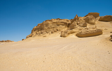 Fototapeta na wymiar Barren desert landscape in hot climate with mountain rock formation