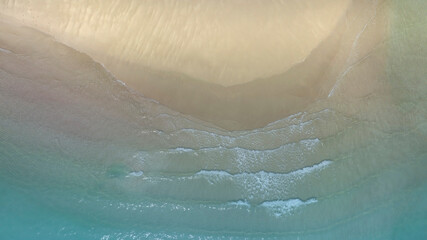 Aerial view with beach in wave of turquoise sea water shot, Top view of beautiful white sand background