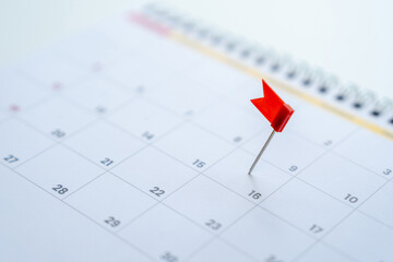Embroidered red pins on a calendar event Planner calendar, planning for business meeting or travel...