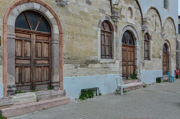 Fototapeta na wymiar wooden doors and facade of Ayios Haralambos Church in Cesme (Izmir province, Turkiye)