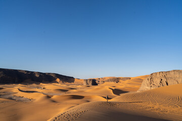 Obraz na płótnie Canvas view in the Sahara desert of Tadrart rouge tassili najer in Djanet City ,Algeria.colorful orange sand, rocky mountains