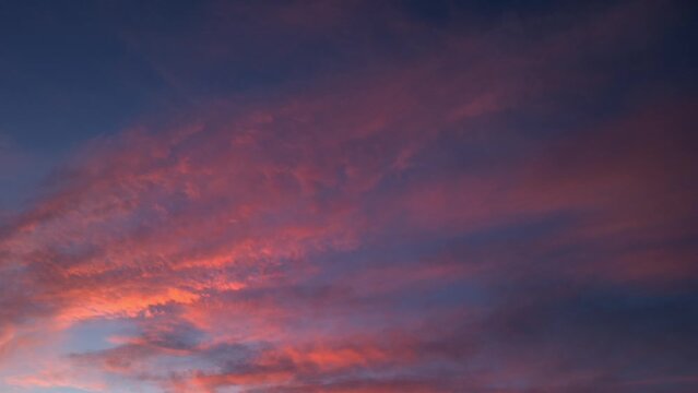 Intense cirrostratus of fire-colored clouds move across the sky