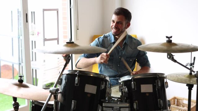 man playing drums in rehearsal studio