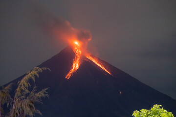 Erupting volcano at night