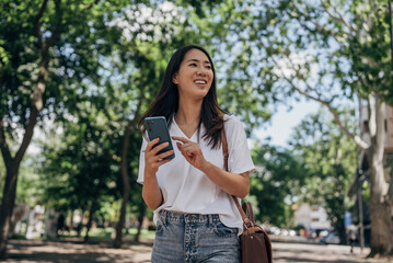 Young woman using smart phone in the city