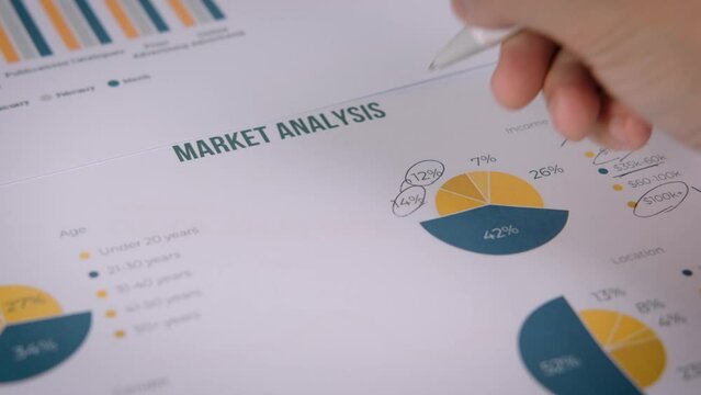 High angle view of businessman hands analyzing marketing charts on paper. Top view of profit check on paper in office Paperwork and financial success. developing a business project and information.