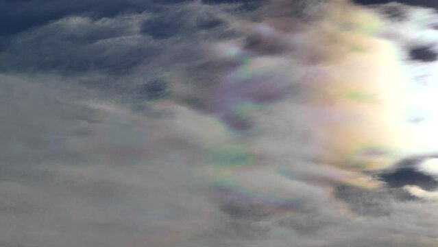 Natural blue sky with colorful decorative clouds moving very slowly - Cloud iridescence, irisation around sun. Observed in warm, sunny, windy autumn weather with mountain winds on October in Poland.