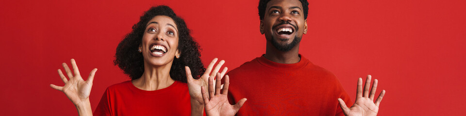 Black happy man and woman smiling and showing their palms
