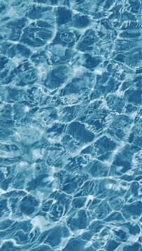 16:9 vertical video. Waves on water surface in swimming pool.