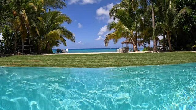 A view of Cemetery Beach on Seven Mile Beach in Grand Cayman Island from a swimming pool.