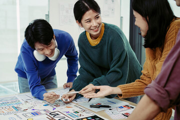 Fototapeta premium Team of Creative Web, Graphic Designer planning, drawing website ux ui app for mobile phone application and development template layout, process to developing prototype wireframe.