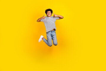 Fototapeta na wymiar Full body photo of active jumping guy thumbs up recommendation cool proposition black friday shopping isolated on yellow color background