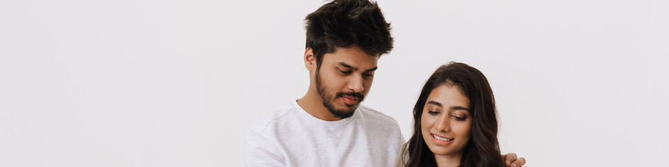 East asian young man and woman smiling and using cellphone together