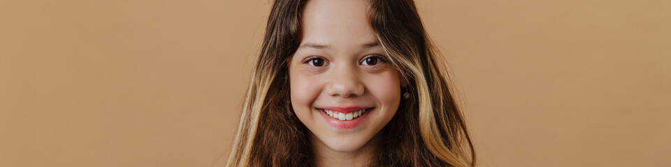 White preteen girl wearing t-shirt smiling and looking at camera