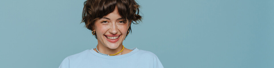 Portrait of young beautiful smiling happy short-haired woman holding phone