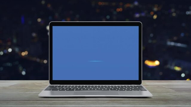 cctv camera flat icon with modern laptop computer on wooden table over blur colorful night light office city tower and skyscraper, Business security and safety online concept