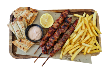 souvlaki greek traditional food from meat, potatoes pie lemon and sauce