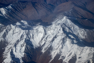 Mountains and rivers from the airplane. Beautiful scenery of nature, the beauty of the mountains.