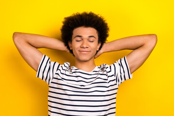 Photo of young relaxed guy take nap closed eyes sleeping after hard student life days lectures isolated over yellow color background