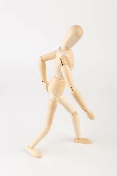 Wooden mannequin figure expressing back pain