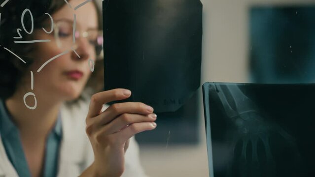Glass board, Scientific researcher Competently looks at X-ray image In the research room. General angle Young expert Works in a working room In a modern science center, testing