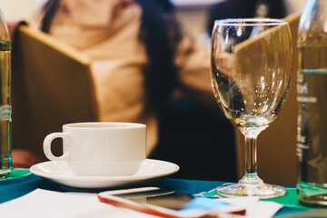 Hot coffee cup on table in hotel seminar hall room