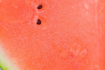 Watermelon in sparkling water. Watermelon slice covered by bubbles in carbonated water. Melon in water with bubbles. Close-up, macro horizontal image.