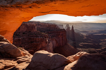 A rock arch at sunset.. Nestled in the southeastern portion of Utah, Canyonlands National Park is one of the most popular places to visit in the area. Often considered the little brother of the Grand 