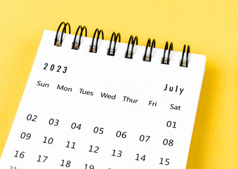 The July 2023 Monthly desk calendar for 2023 year on yellow background.