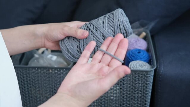Weaving macrame at home. Hand of a woman when she is making macrame.