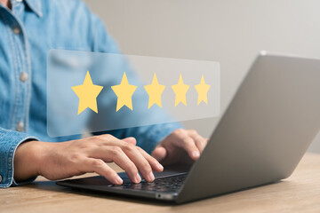 customer satisfaction survey concept business people use laptops Touch the happy smiley icon....