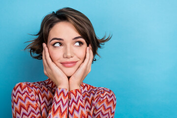 Fototapeta premium Photo of thoughtful pretty woman dressed striped top arms cheeks looking empty space isolated blue color background
