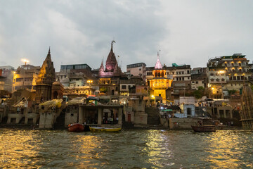 India Varanasi ganga ghat at night, view of the crowded banks of people and funeral pyres